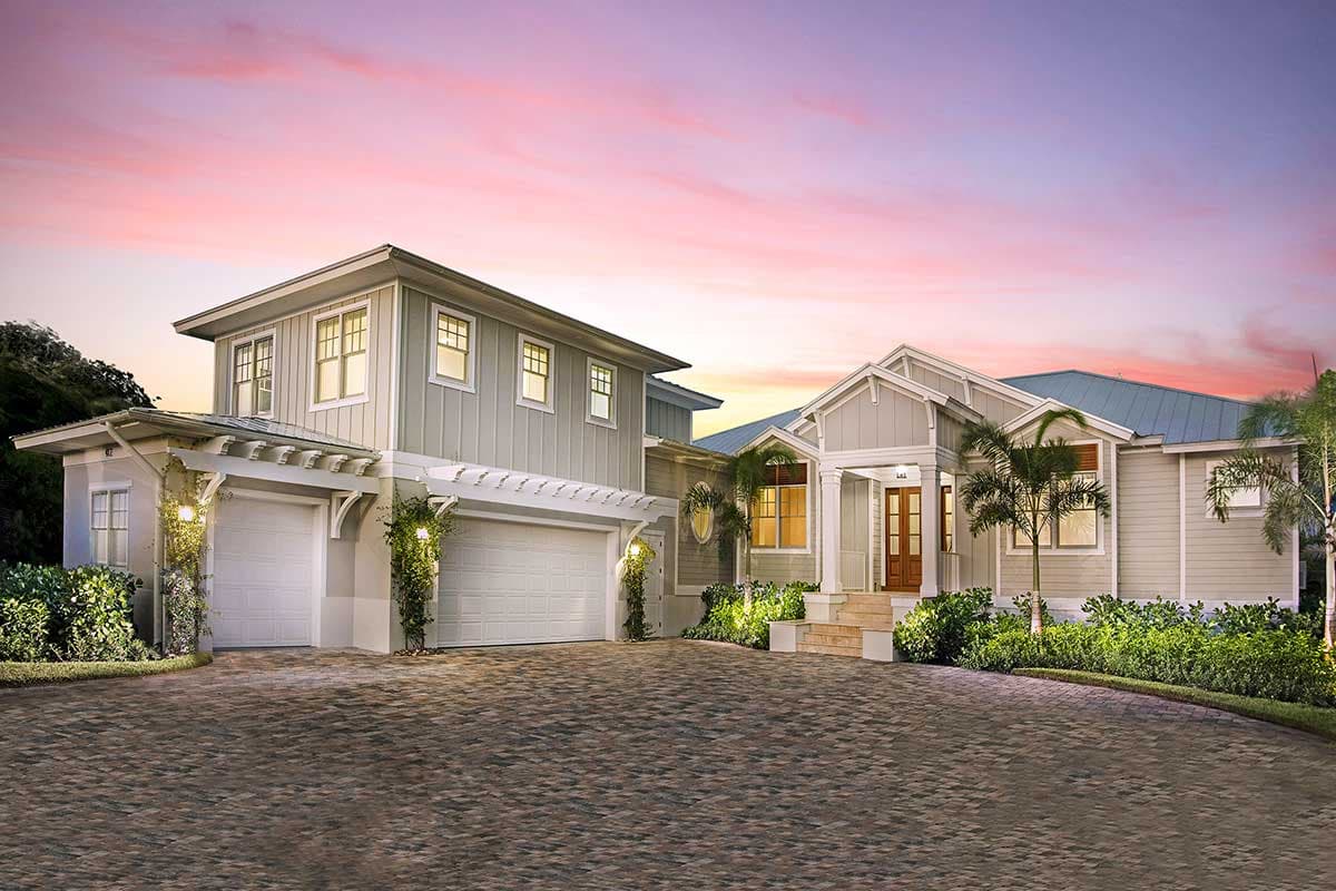 House plan exterior with Craftsman style, two stories, pergola over garage, gabled roof, and columned entry porch.