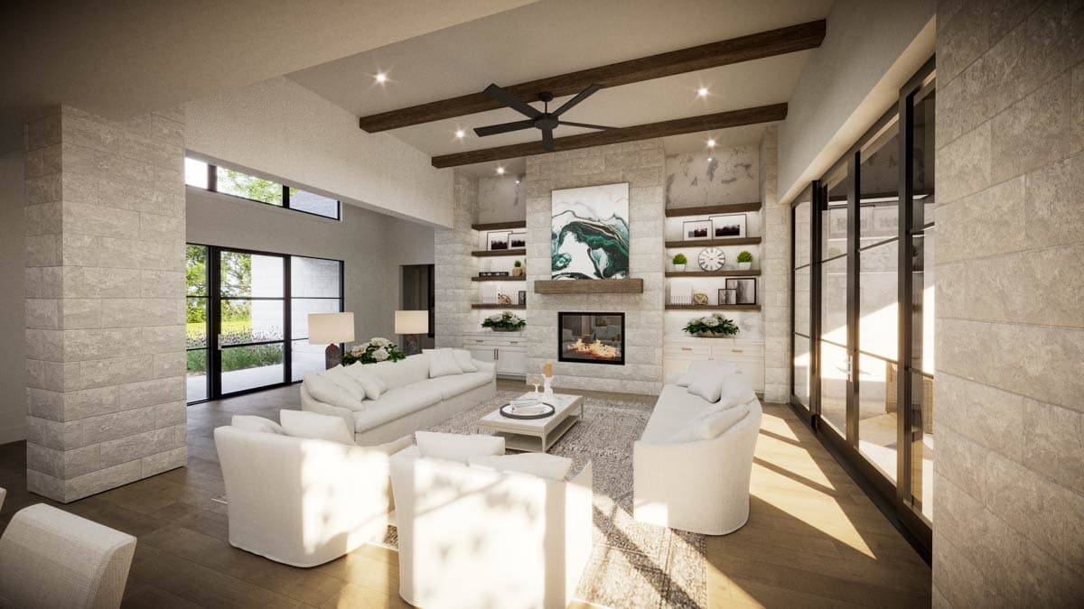 Spacious, modern living room with fireplace, white sofas, and large windows. Decorated with stone walls and wooden accents.