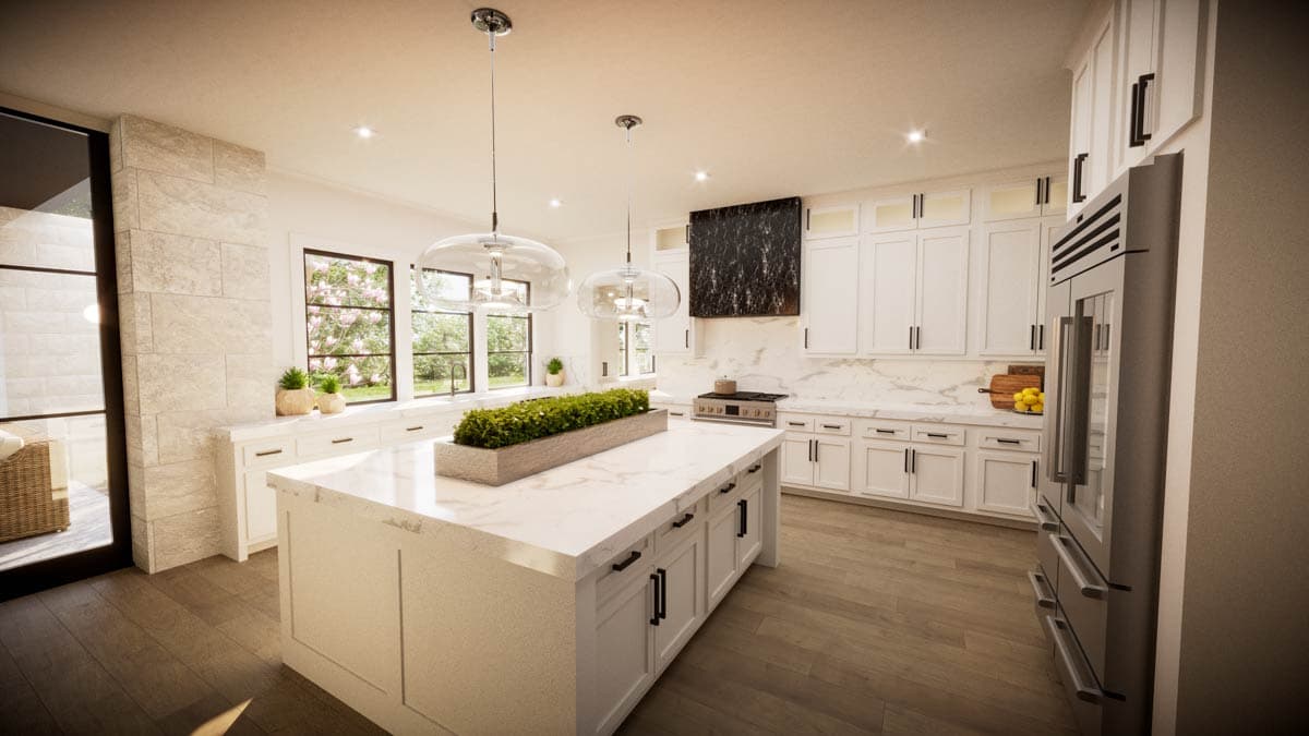 Modern white kitchen with a large island, marble countertops, and large windows overlooking a garden.
